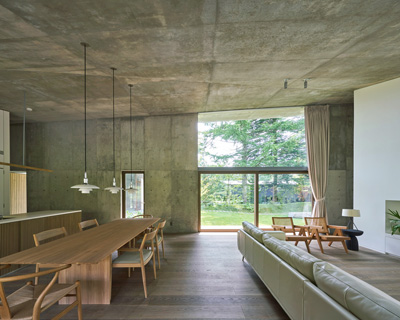 r.e.a.d. & architects tops 'symbiotic house' with sloping concrete roof in karuizawa, japan