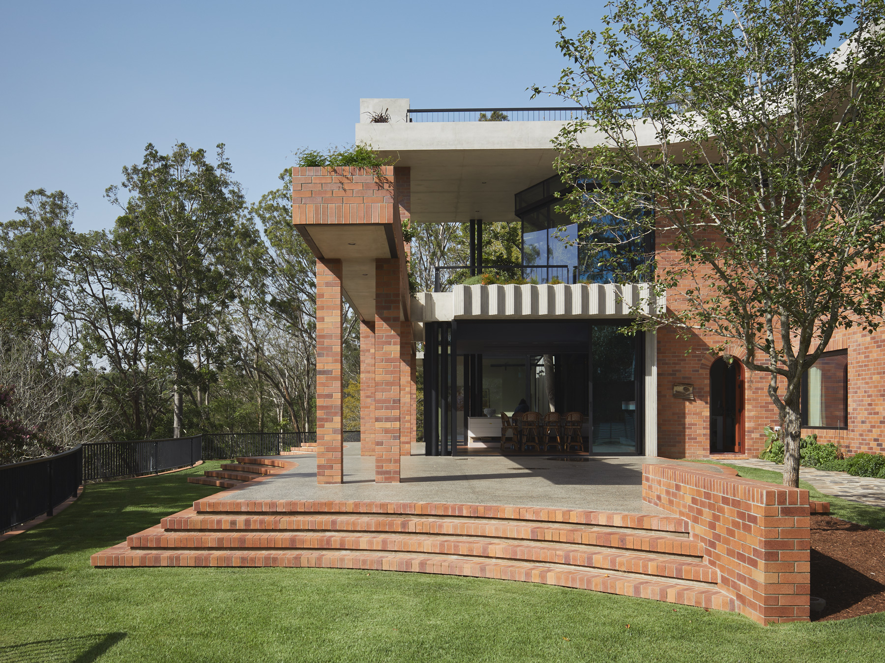 jesse bennett studio builds australian house with brick archways + concrete roof cap