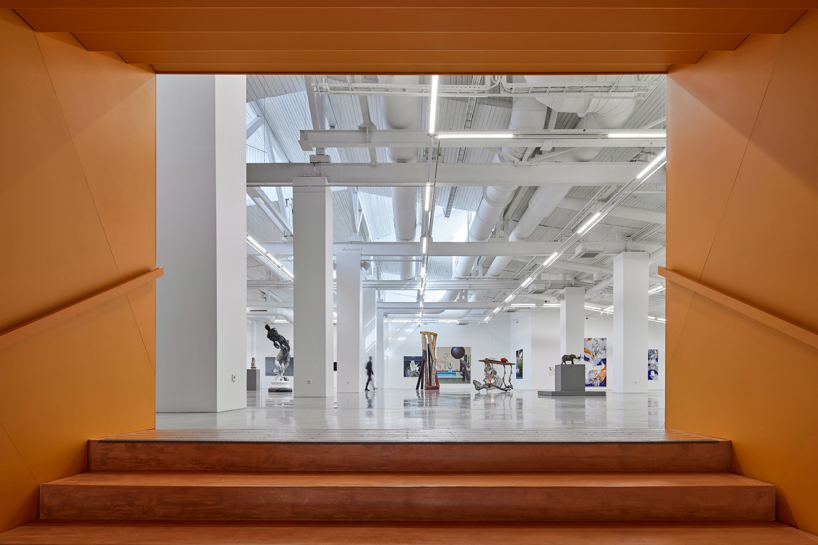 energetic orange adorns the zuzeum art center in riga, designed by annvil designboom