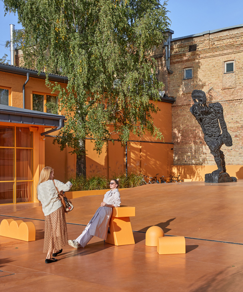 energetic orange adorns the zuzeum art center in riga, designed by annvil