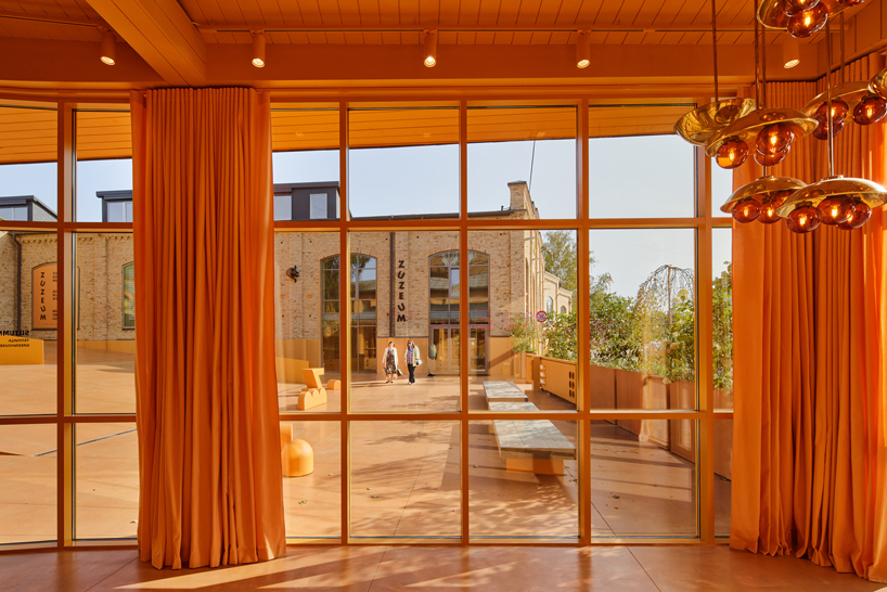 energetic orange adorns the zuzeum art center in riga, designed by annvil designboom