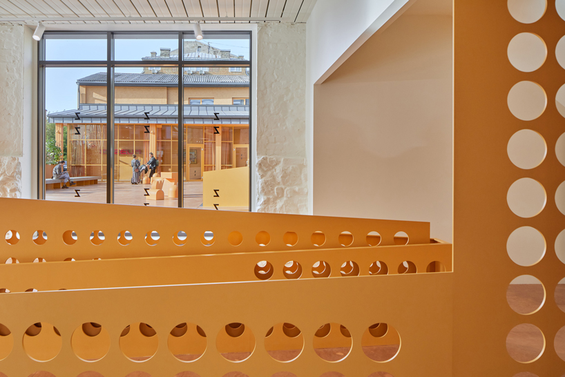 energetic orange adorns the zuzeum art center in riga, designed by annvil designboom