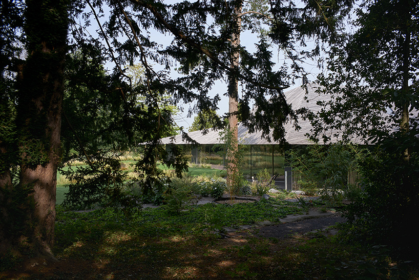 TANK conceals 'maison mouvaux' beneath sculptural wooden roof in northern france