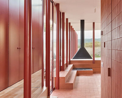 elevated with red pilotis, arquitectura-G's casa sant antoni overlooks barcelona