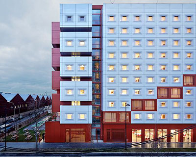 white & bright red perforated metal facade clads student housing by BFV in france