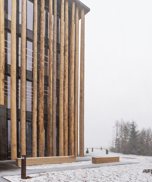 brückner & brückner architekten wraps 'hohes holz' office in a façade of spruce trunks