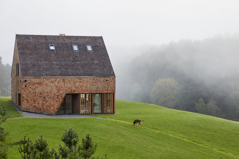 arches wraps 'cedar house' in façade of wood shingles in lithuania