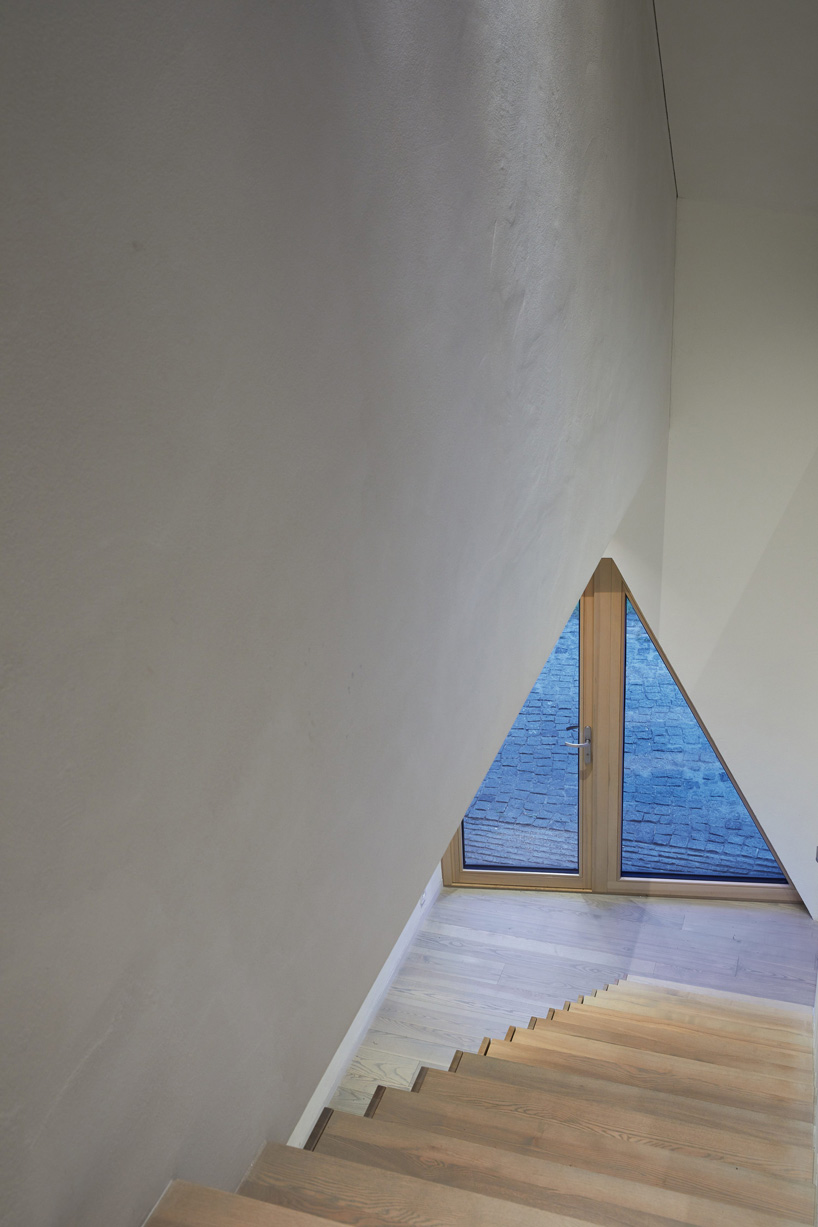 arches wraps 'cedar house' in façade of wood shingles in lithuania