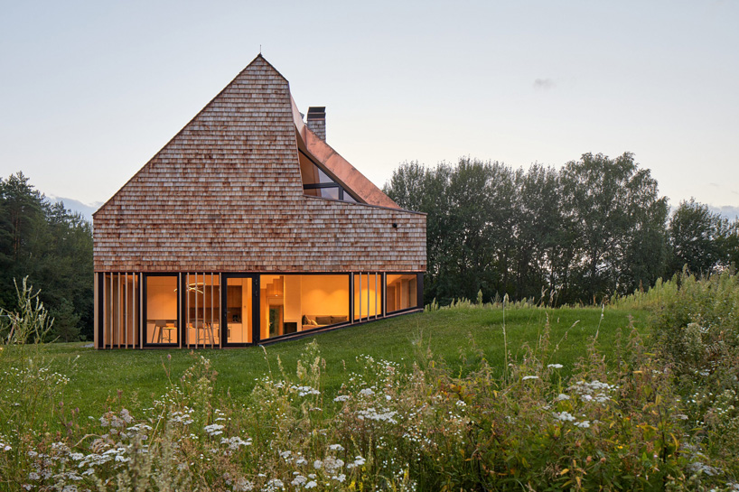 exterior of cedar house by arches in lithuania