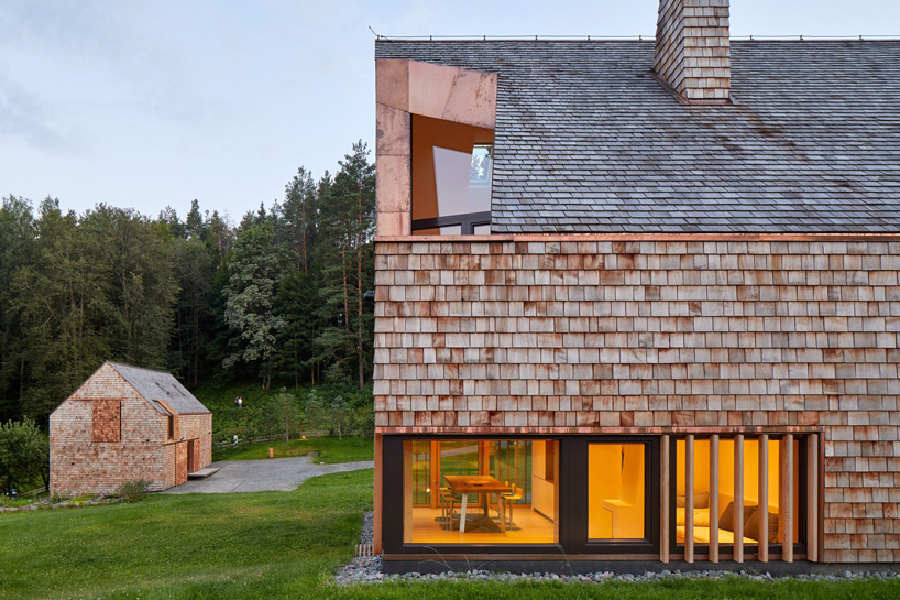 exterior of cedar house by arches in lithuania