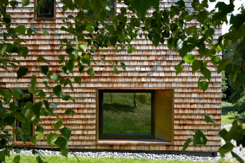 arches wraps 'cedar house' in façade of wood shingles in lithuania