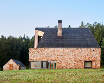 arches wraps 'cedar house' in façade of wood shingles in lithuania