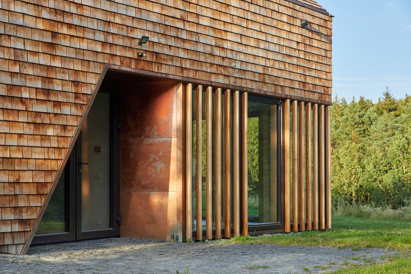 arches wraps 'cedar house' in façade of wood shingles in lithuania