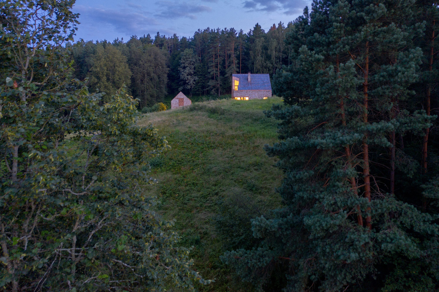 arches wraps 'cedar house' in façade of wood shingles in lithuania
