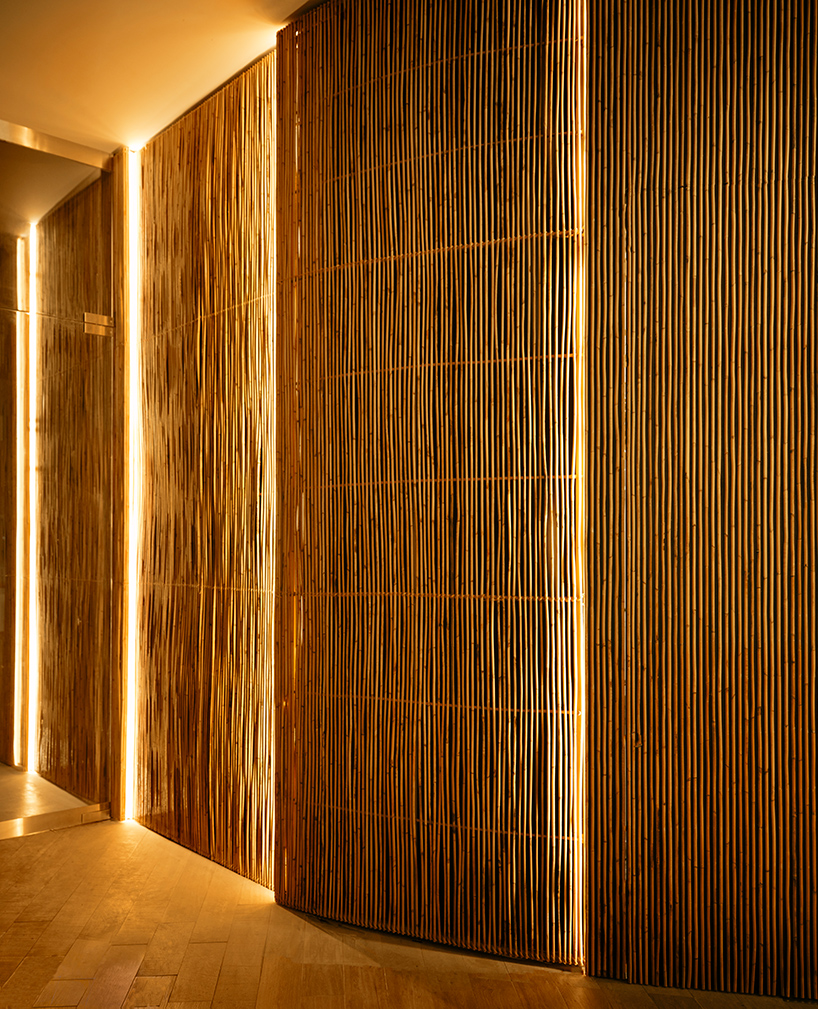 billowing rattan columns by enter projects occupy bangkok's spice & barley interior