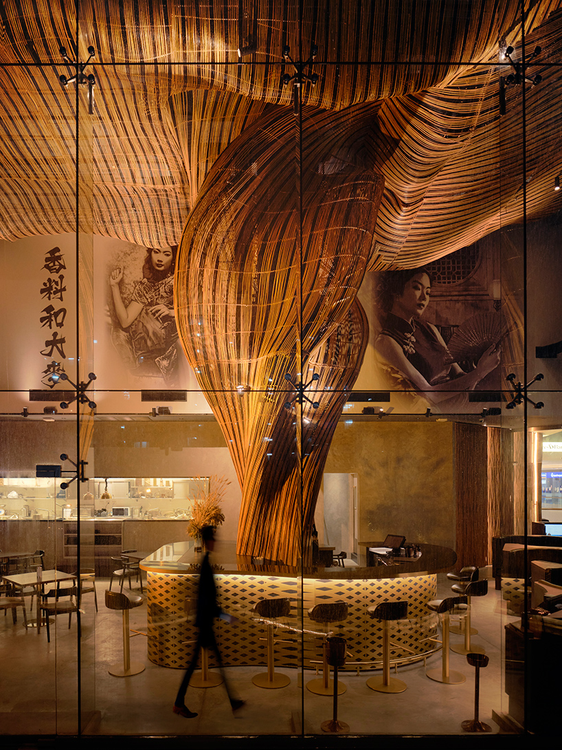 billowing rattan columns by enter projects occupy bangkok's spice & barley interior