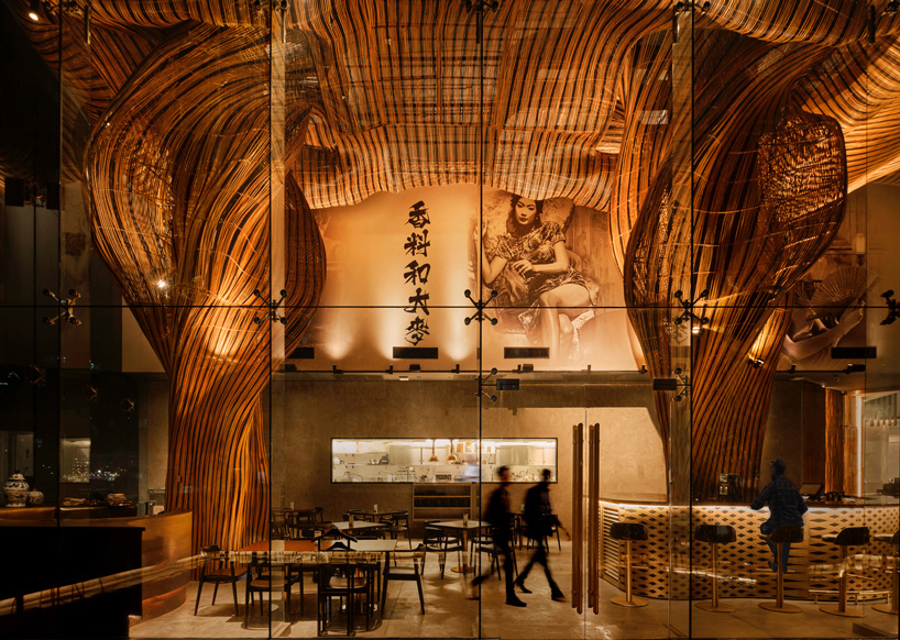 billowing rattan columns by enter projects occupy bangkok's spice & barley interior