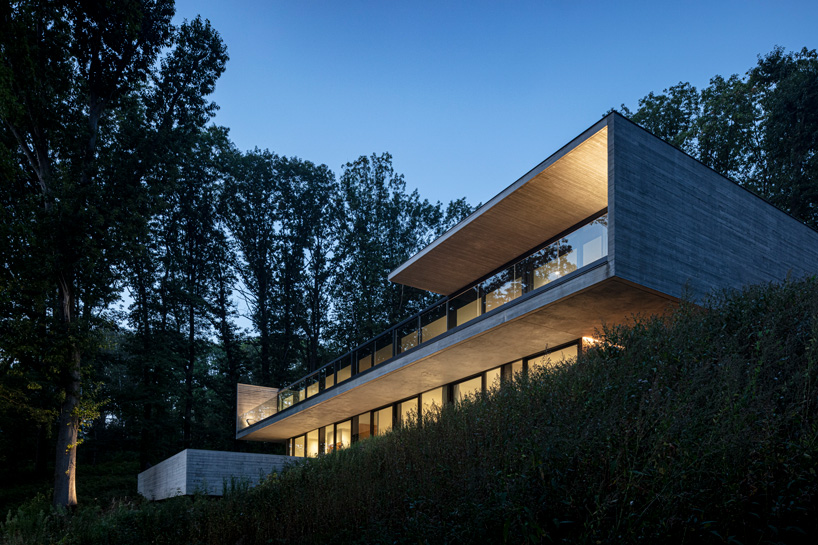 linear concrete residence by govaert & vanhoutte architects blends in belgian forest