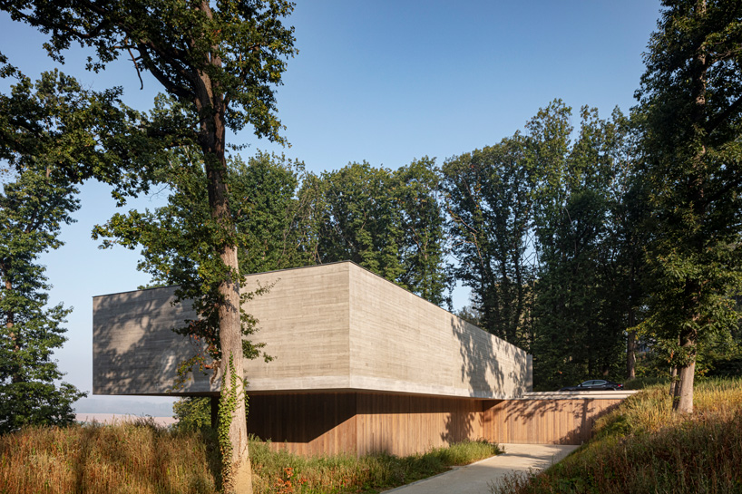 linear concrete residence by govaert & vanhoutte architects blends in belgian forest