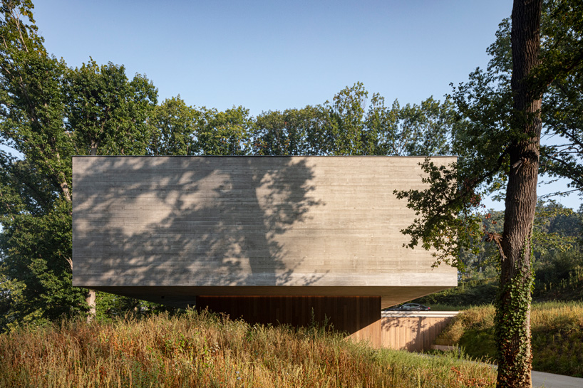 linear concrete residence by govaert & vanhoutte architects blends in belgian forest