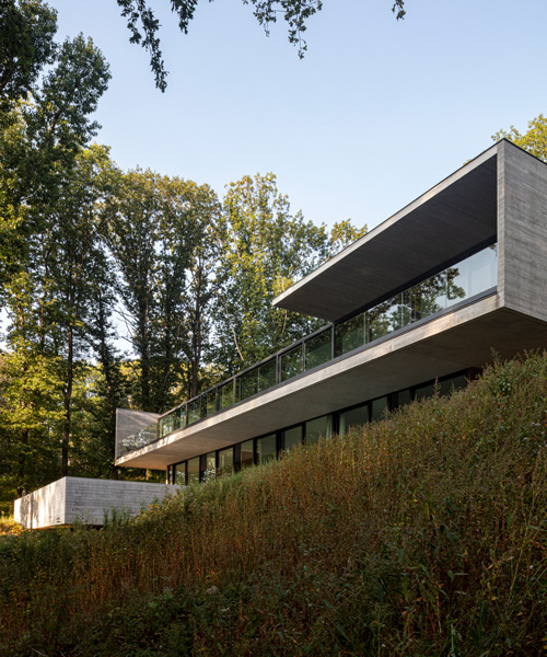 linear concrete residence by govaert & vanhoutte architects blends in belgian forest