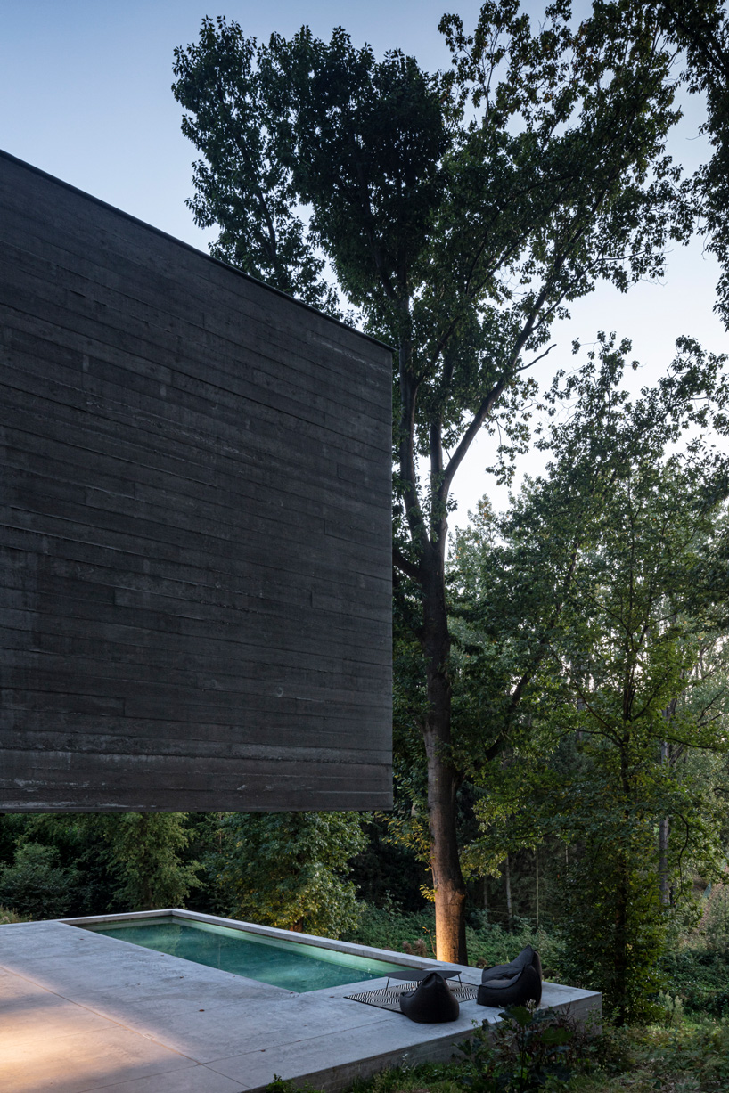 linear concrete residence by govaert & vanhoutte architects blends in belgian forest