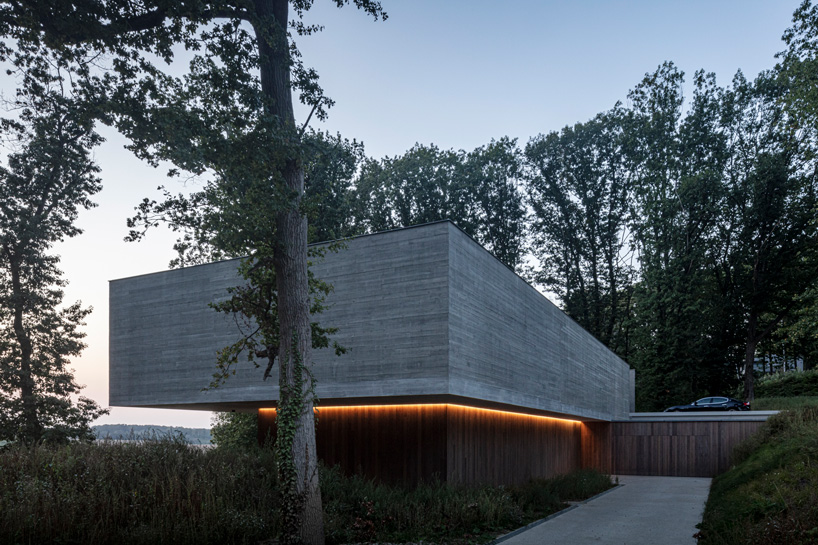 linear concrete residence by govaert & vanhoutte architects blends in belgian forest