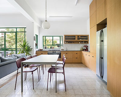 green tones and natural oak surfaces adorn apartment interior in tel aviv