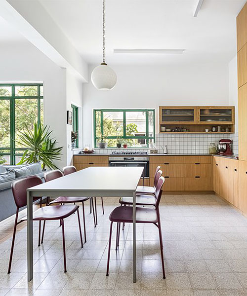 green tones and natural oak surfaces adorn apartment interior in tel aviv