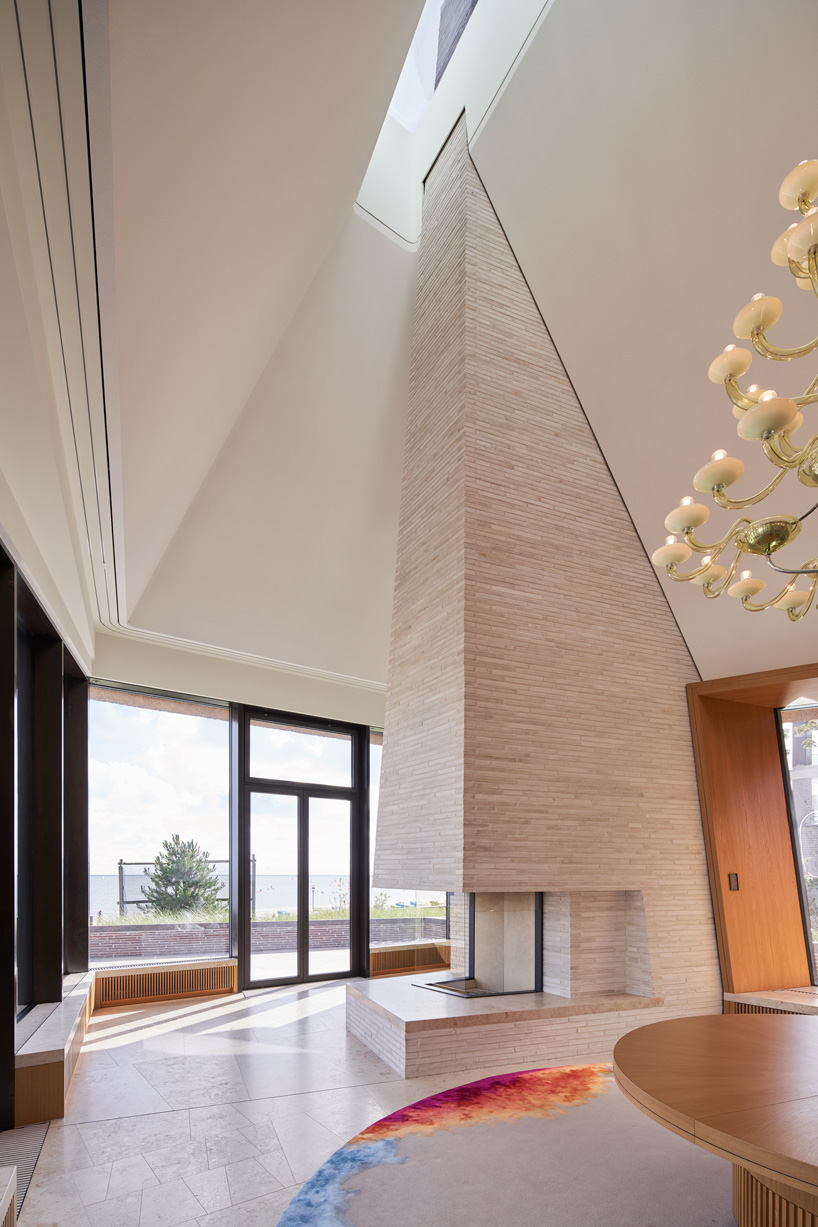 thatched hip roof tops hubschmitz architekten's house on föhr island, germany