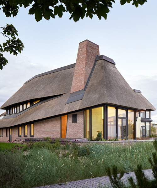 thatched hip roof tops hubschmitz architekten's house on föhr island, germany