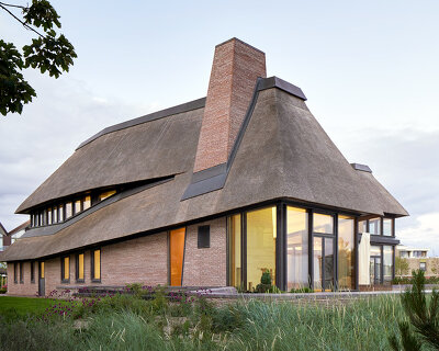 thatched hip roof tops hubschmitz architekten's house on föhr island, germany