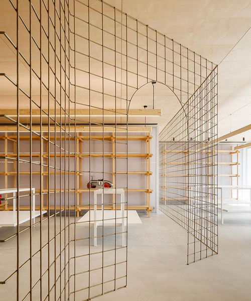 stu.dere divides its 'warehouse morinho' interior with an expressive gridded screen