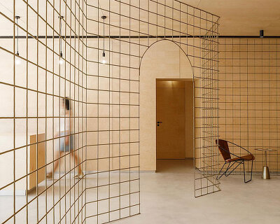 stu.dere divides its 'warehouse morinho' interior with an expressive gridded screen