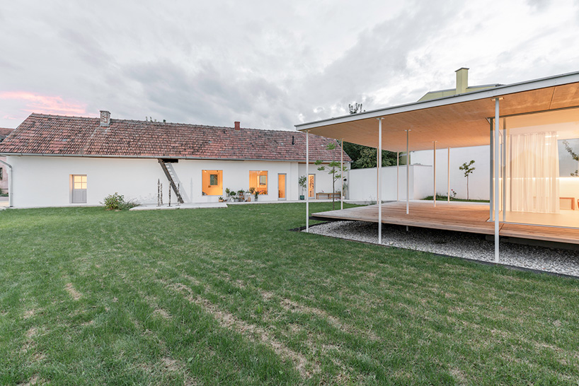 maximilian eisenköck completes a white, floating pavilion for sculpture artist in austria