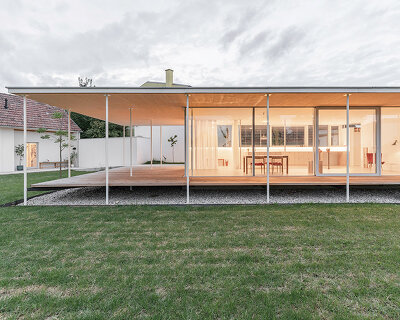 maximilian eisenköck completes a white, floating pavilion for sculpture artist in austria
