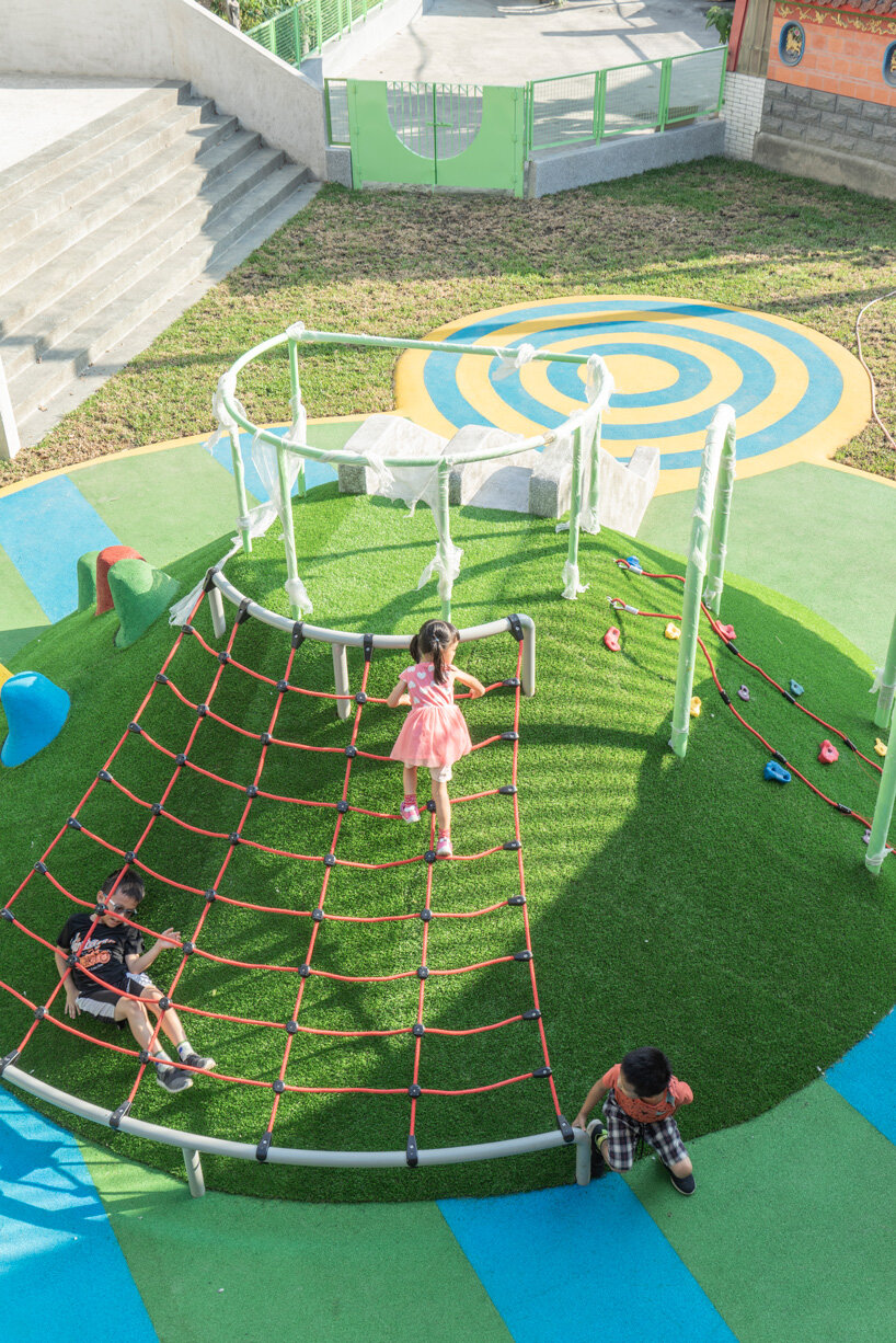 bright yellow columns complete ospacearchitects' tung yuan kindergarten in taiwan