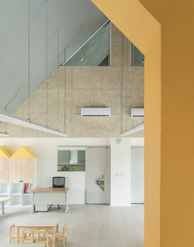 bright yellow columns complete ospacearchitects' tung yuan kindergarten in taiwan