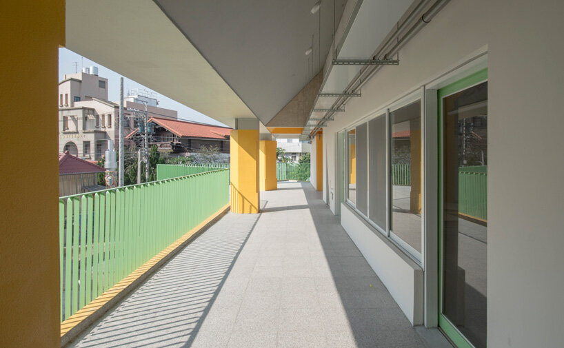bright yellow columns complete ospacearchitects' tung yuan kindergarten in taiwan