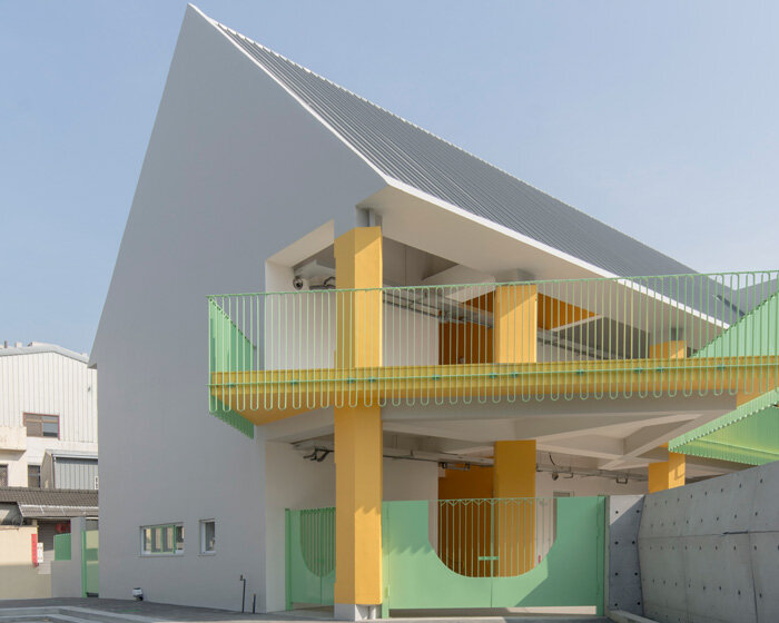 bright yellow columns complete ospacearchitects' tung yuan kindergarten in taiwan