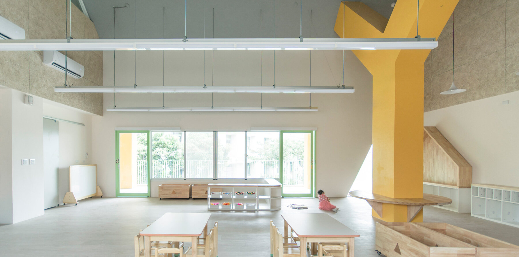 bright yellow columns complete ospacearchitects' tung yuan kindergarten in taiwan