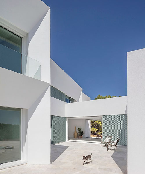'patio house' by nomo studio offers unobstructed sea views in menorca, spain