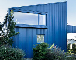 sigurd larsen clads monolithic danish house in blue corrugated steel
