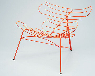 šimon galanský twists & turns bright orange steel rods into the 'sinuo chair'