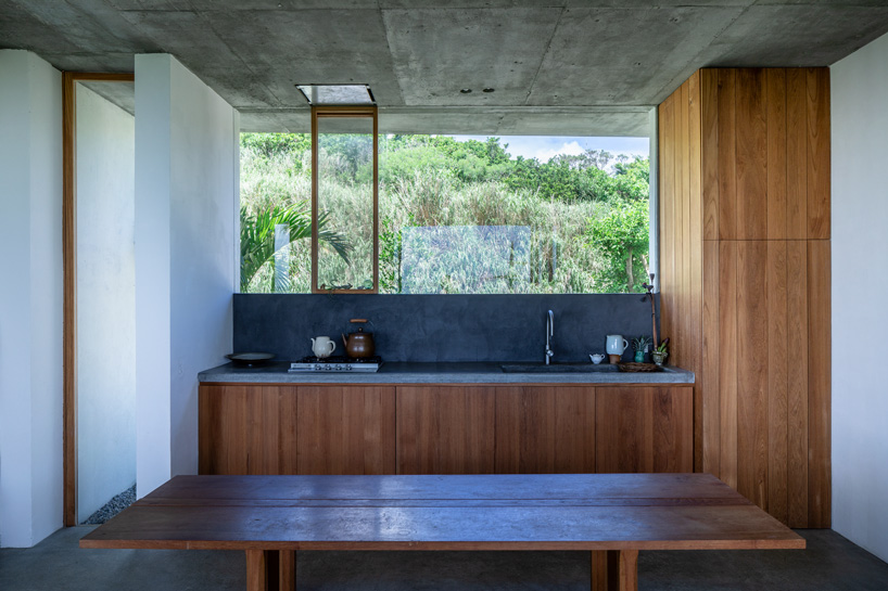 studio cochi architects' concrete house opens toward the lush landscape of okinawa island