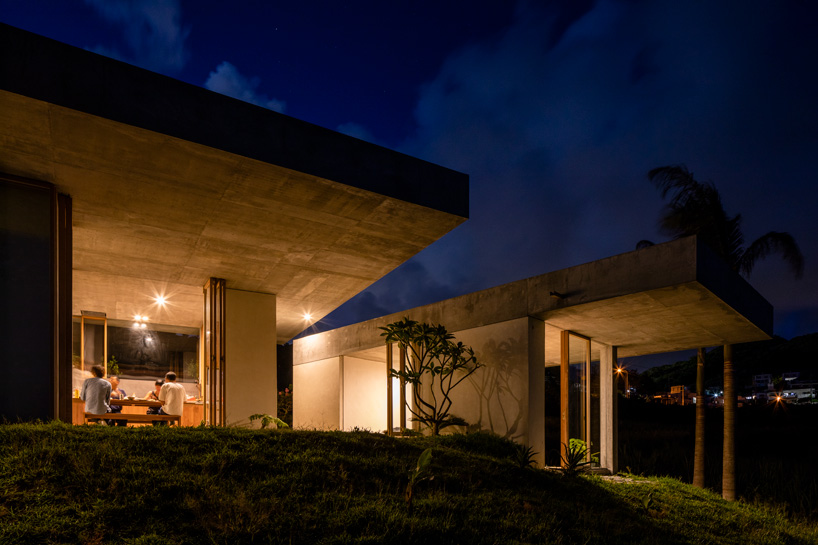 studio cochi architects' concrete house opens toward the lush landscape of okinawa island
