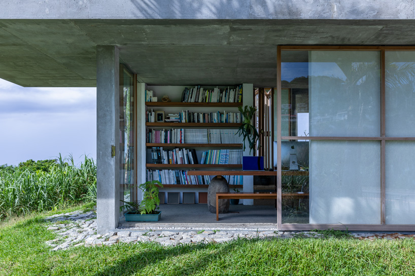 studio cochi architects' concrete house opens toward the lush landscape of okinawa island