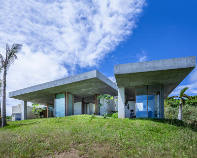 studio cochi architects' concrete house opens toward the lush landscape of okinawa island