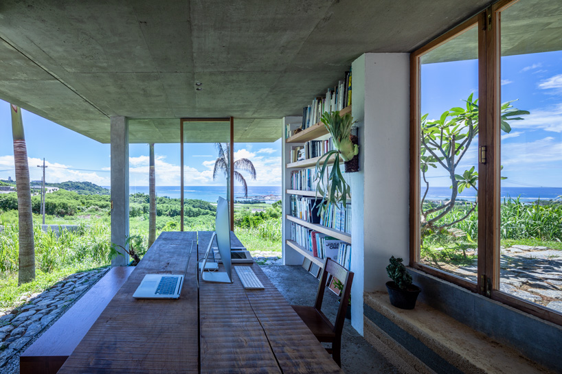 studio cochi architects' concrete house opens toward the lush landscape of okinawa island