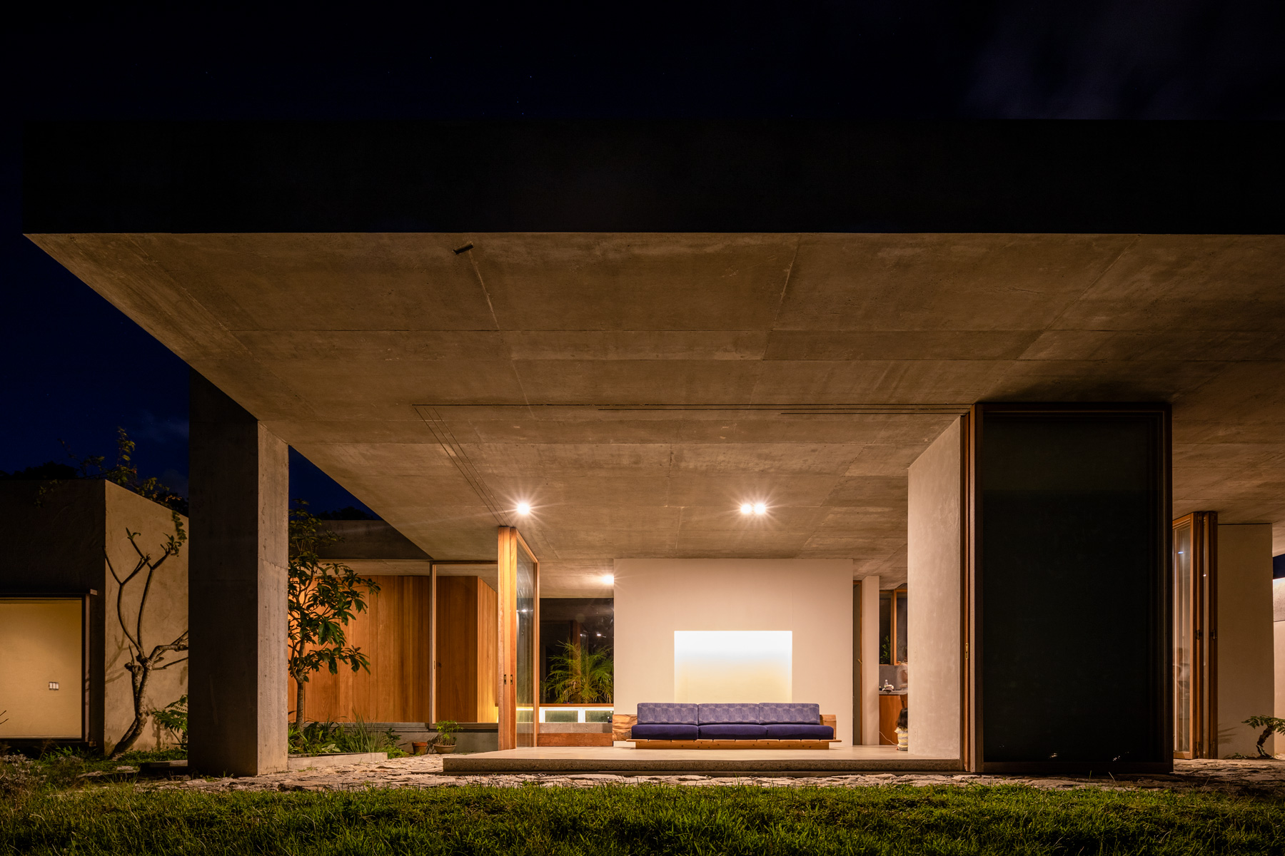 studio cochi architects' concrete house opens toward the lush landscape of okinawa island